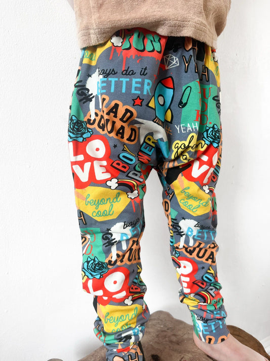 Kids harem pants with colourful graffiti-style slogan and street print